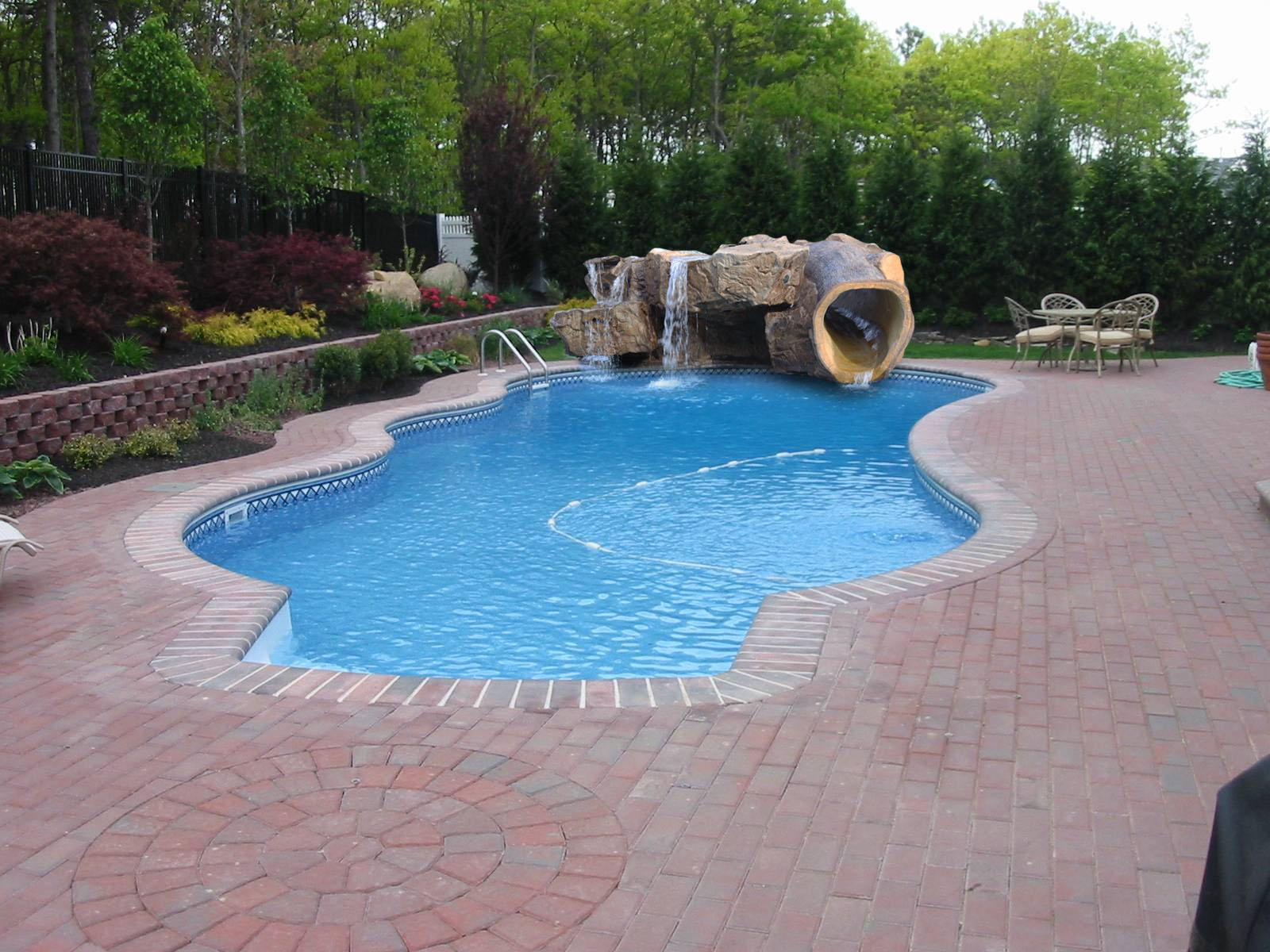 poolside water feature with slide, stairs and grotto